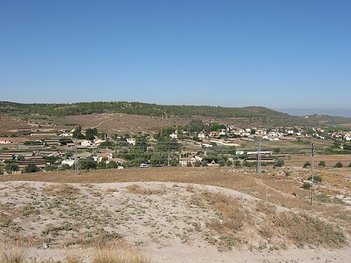 panorama looking west of a region including Khirbet Umm Jina, which is visible by the path going up the hill in the distance